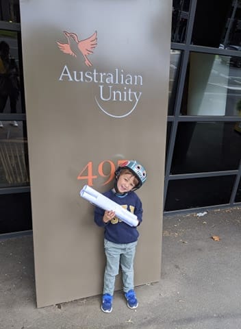 child delivering letters and care packages to local community