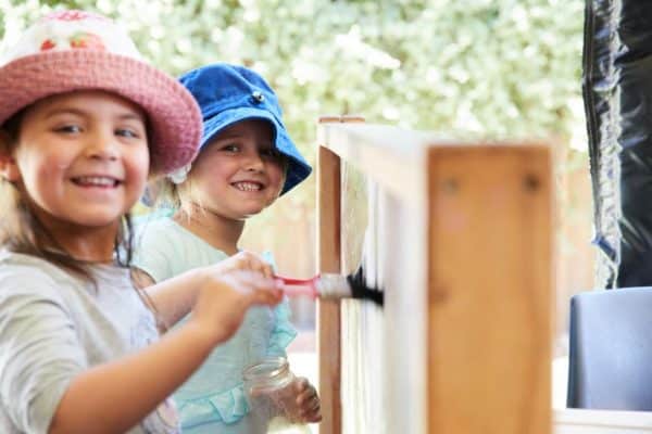 children painting and participating in active play