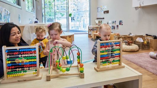 Children playing with Educator learning numbers at Guardian Margaret street