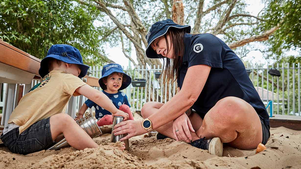 Children playing with educator in sand at Freshwater