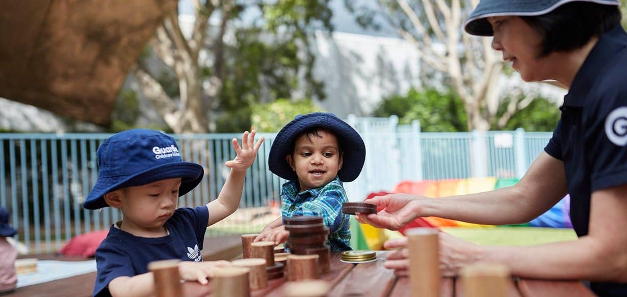 Children interacting with Educator outside at Pymble