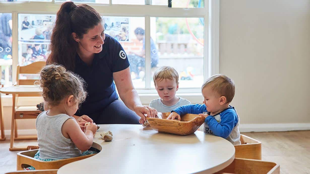 Educator interacting with children at Wahroonga inside