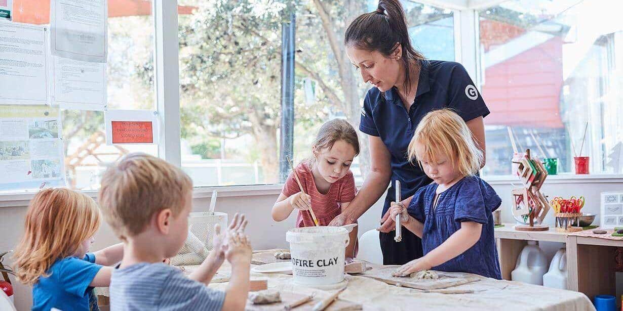 Children painting with educator inside at Maroubra East
