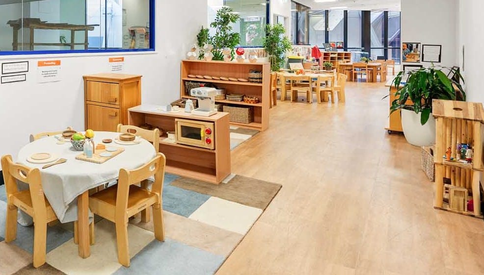 Engaging learning space at Guardian Childcare George Street NSW, filled with children's artwork, natural light, and organised activity tables to foster creativity and exploration.