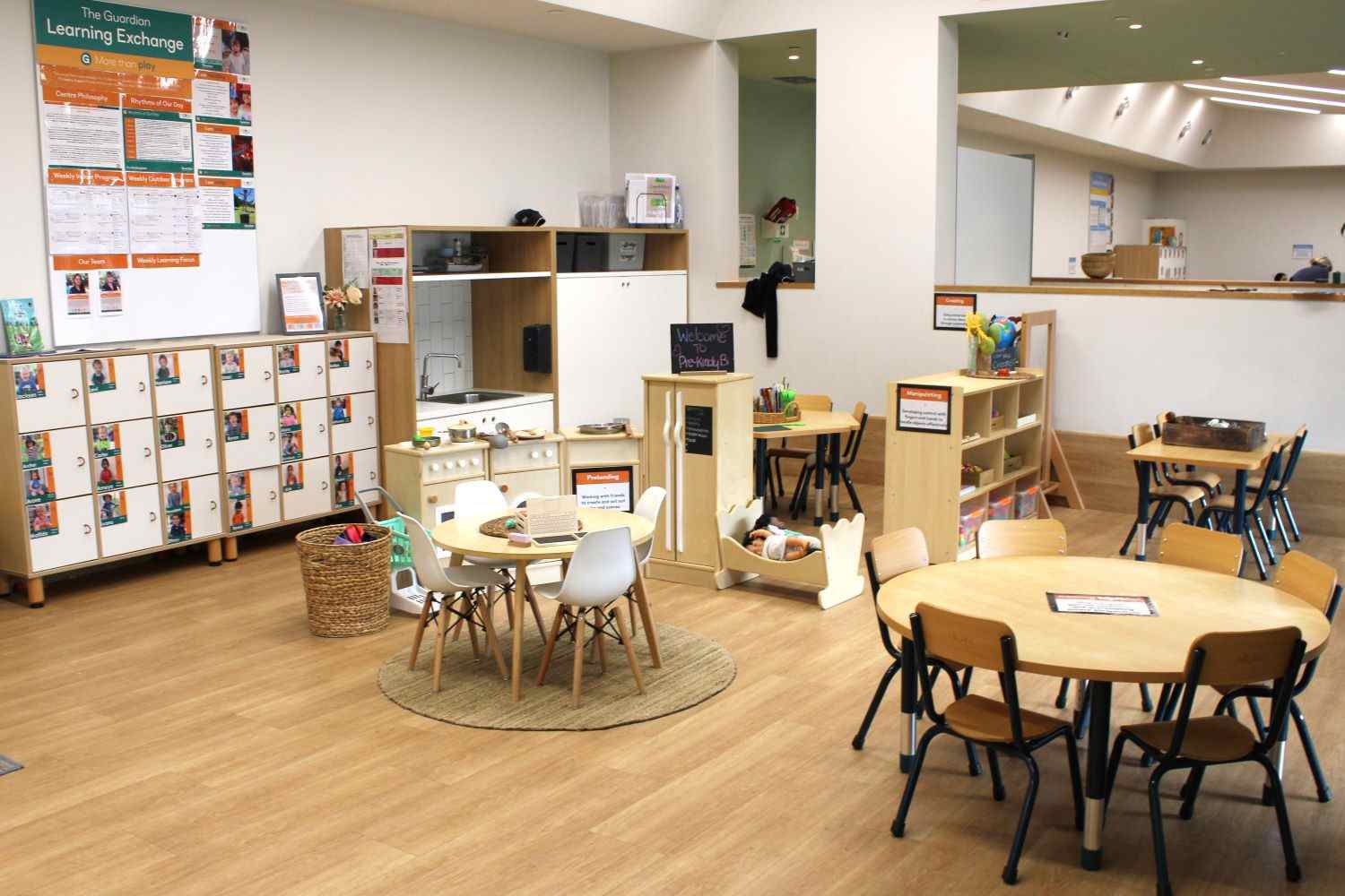 Bright and organised indoor learning space at Guardian Childcare Springfield Southern Cross Circuit, QLD, featuring home corner, activity tables, and children's lockers.