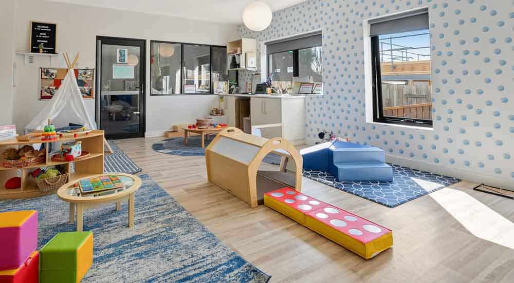 Spacious and well-organised classroom at Guardian Childcare Pascoe Vale, showcasing distinct play zones for diverse early learning experiences and a bright, natural light-filled environment.