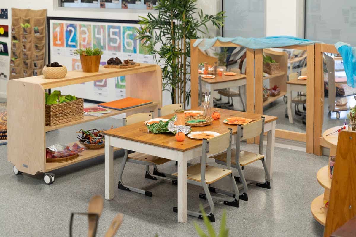 Classroom dining area at Guardian Childcare Hamilton QLD, set for a healthy meal with child-sized tables, seasonal pumpkin decorations, and natural light.