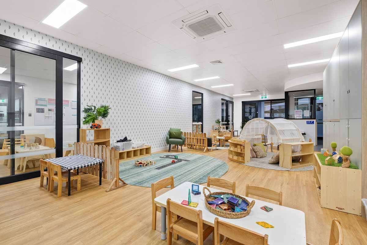 Diverse play-based learning areas at Guardian Childcare Manifold Heights, featuring activity tables, road rug, and teepee for varied engagement.