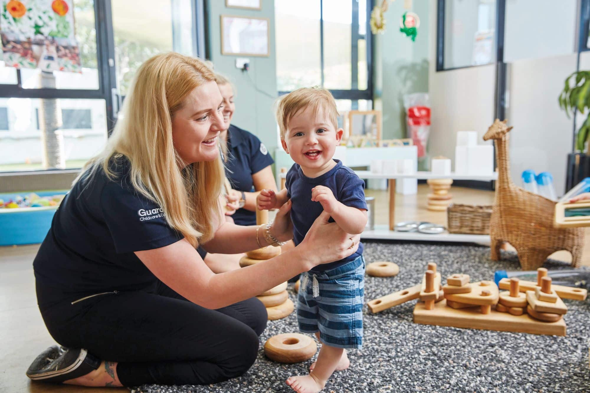 Baby educator with smiling child at Guardian Childcare centre