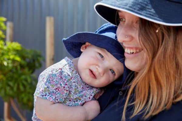 Baby cuddles educator at Guardian Childcare centre