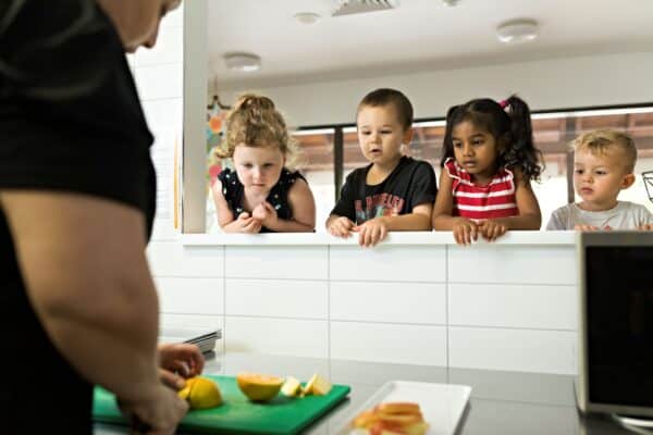 Children looking at food prep in a Guardian Childcare centre