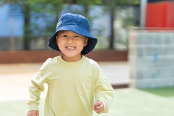 Smiling child wearing hat at Guardian Childcare centre