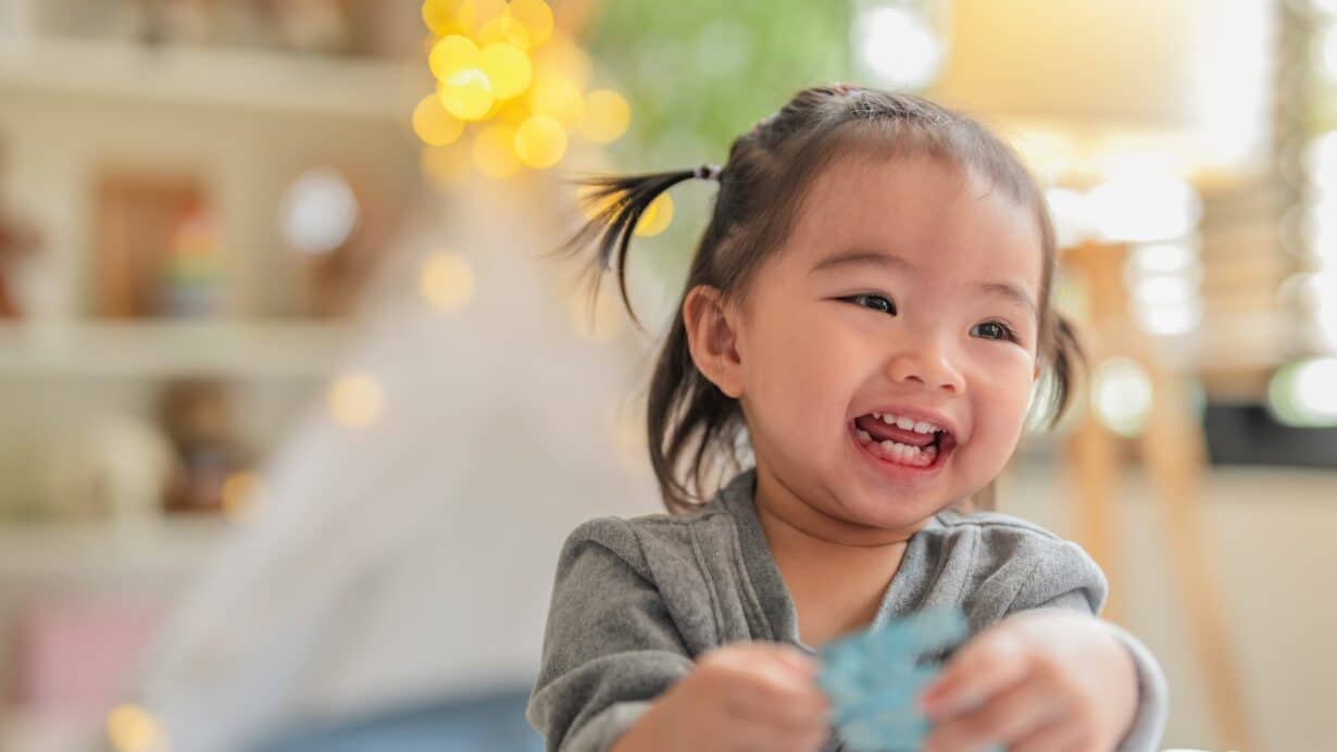 Happy toddler girl laughing at early learning centre