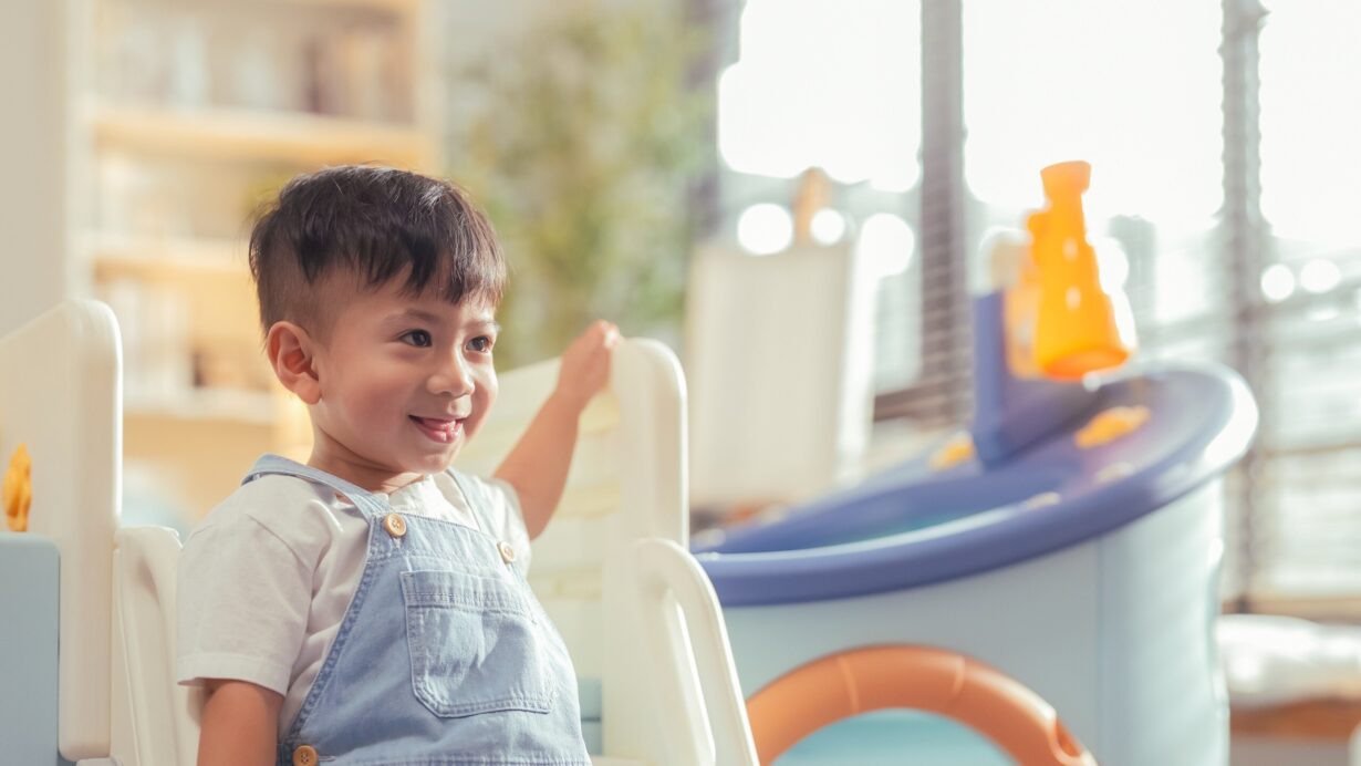 Smiling boy on play equipment at a childcare centre